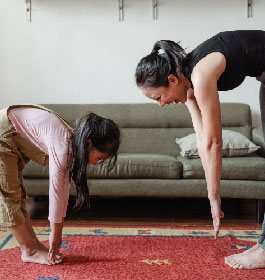 Mother and Daughter Stretching showing fitness is fun together
